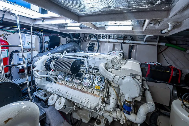 Slide: The Image of Engine room of a 2008 Sea Ray 60 Sundancer yacht, showcasing detailed machinery. - 70