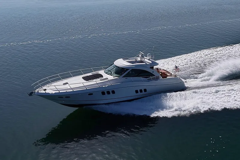Slide: The Image of 2008 Sea Ray 60 Sundancer yacht cruising on open water, creating a dynamic wake. - 12