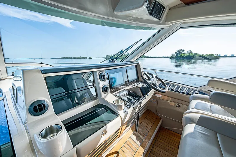 Slide: The Image of Helm of 2008 Sea Ray 60 Sundancer yacht with modern controls and scenic water view. - 18