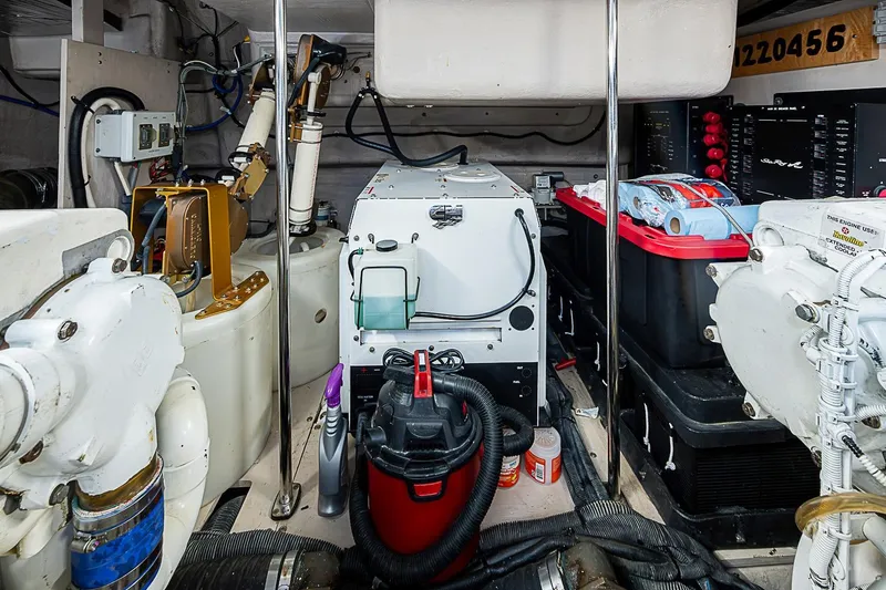 Slide: The Image of Engine room of a 2008 Sea Ray 60 Sundancer yacht, featuring mechanical equipment and storage. - 71