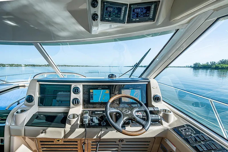 Slide: The Image of Helm of 2008 Sea Ray 60 Sundancer yacht with navigation screens and steering wheel. - 16