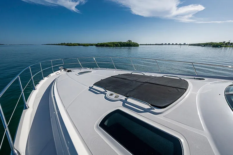 Slide: The Image of 2008 Sea Ray 60 Sundancer yacht cruising on calm waters under a clear blue sky. - 56