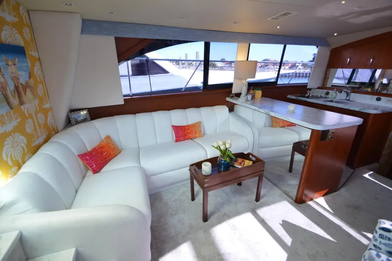 Slide: The Image of Luxurious interior of 1995 Ocean 48 Cockpit Motor Yacht with white seating and vibrant decor. - 16