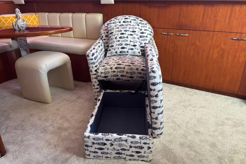 Slide: The Image of Cozy yacht interior with patterned chair, storage, and elegant seating area. Ocean 48 Cockpit Motor Yacht, 1995. - 19