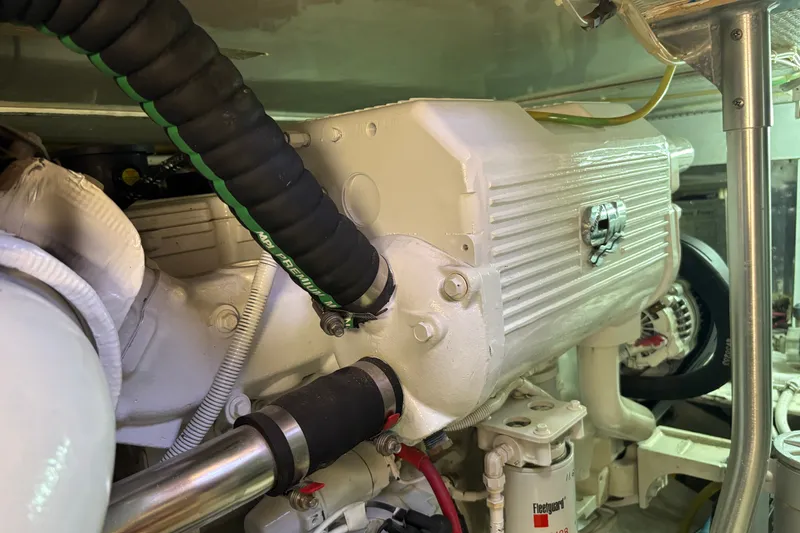 Slide: The Image of Engine room of 1995 Ocean 48 Cockpit Motor Yacht, showcasing mechanical components and hoses. - 54