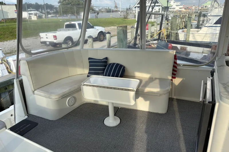 Slide: The Image of Cozy seating area on 1995 Ocean 48 Cockpit Motor Yacht with striped cushions. - 36