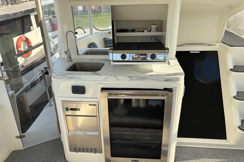 Slide: The Image of 1995 Ocean 48 Cockpit Motor Yacht interior with kitchenette and appliances. - 39