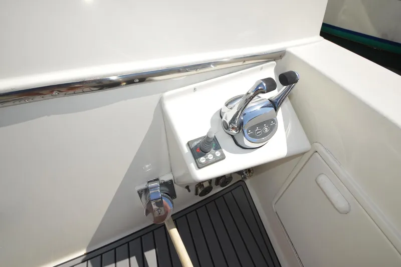 Slide: The Image of Control panel of a 1995 Ocean 48 Cockpit Motor Yacht, featuring dual levers and joystick. - 62