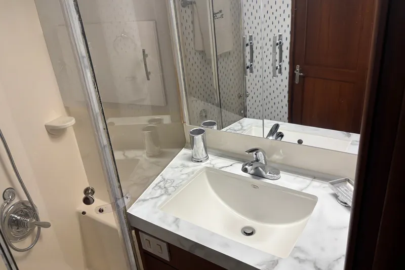 Slide: The Image of Bathroom interior of 1995 Ocean 48 Cockpit Motor Yacht with marble countertop and shower. - 30