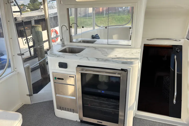 Slide: The Image of Luxurious 1995 Ocean 48 Cockpit Motor Yacht interior with kitchenette and modern appliances. - 38