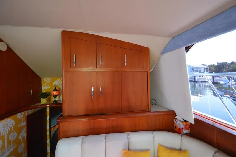Slide: The Image of Interior of 1995 Ocean 48 Cockpit Motor Yacht with wooden cabinetry and waterfront view. - 24