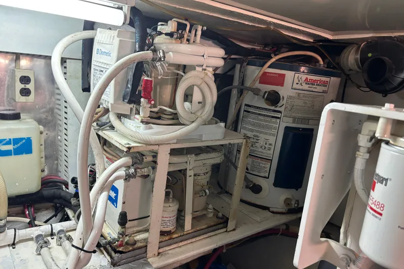 Slide: The Image of Engine room of 1995 Ocean 48 Cockpit Motor Yacht with mechanical equipment and wiring. - 52