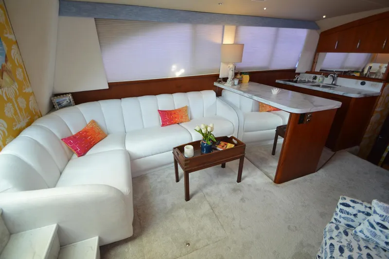 Slide: The Image of Luxurious interior of 1995 Ocean 48 Cockpit Motor Yacht with white seating and vibrant cushions. - 7