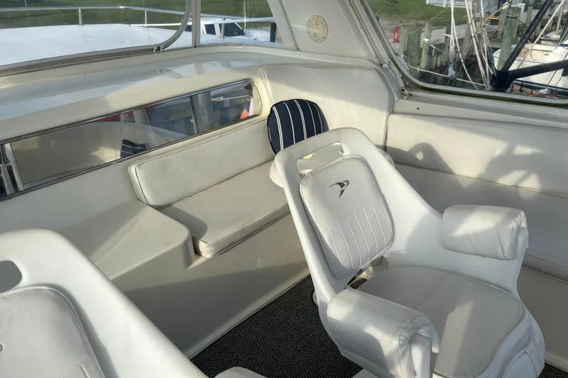 Slide: The Image of Interior of 1995 Ocean 48 Cockpit Motor Yacht with white seating and helm chair. - 44