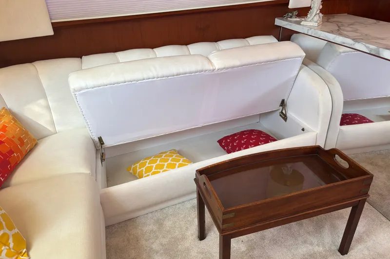 Slide: The Image of Interior of 1995 Ocean 48 Cockpit Motor Yacht with white sofa storage and colorful cushions. - 17