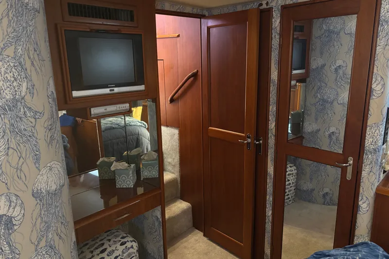 Slide: The Image of Interior of 1995 Ocean 48 Cockpit Motor Yacht with wood paneling and nautical decor. - 23