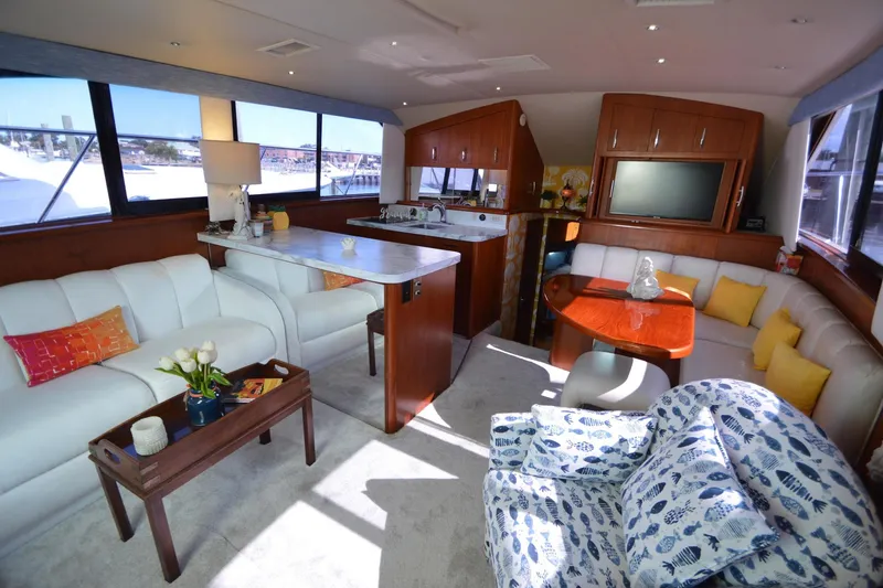 Slide: The Image of Luxurious interior of a 1995 Ocean 48 Cockpit Motor Yacht with elegant seating and decor. - 17