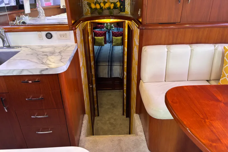 Slide: The Image of Interior of 1995 Ocean 48 Cockpit Motor Yacht with cozy seating and elegant wood finishes. - 15