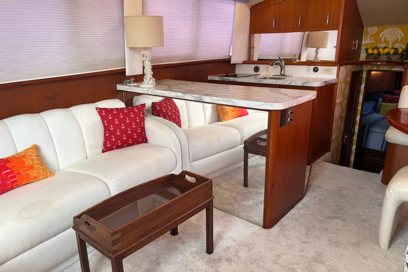 Slide: The Image of Luxurious 1995 Ocean 48 Cockpit Motor Yacht interior with elegant seating and modern kitchenette. - 10