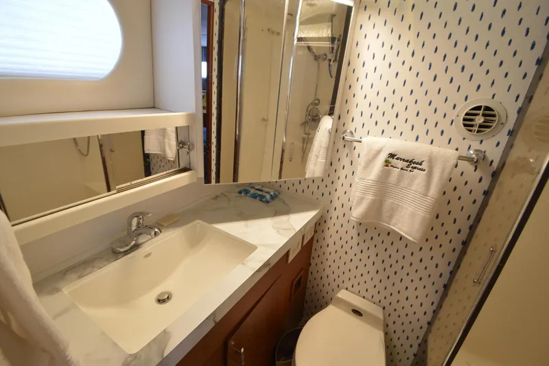 Slide: The Image of Bathroom interior of 1995 Ocean 48 Cockpit Motor Yacht with sink and towel. - 36
