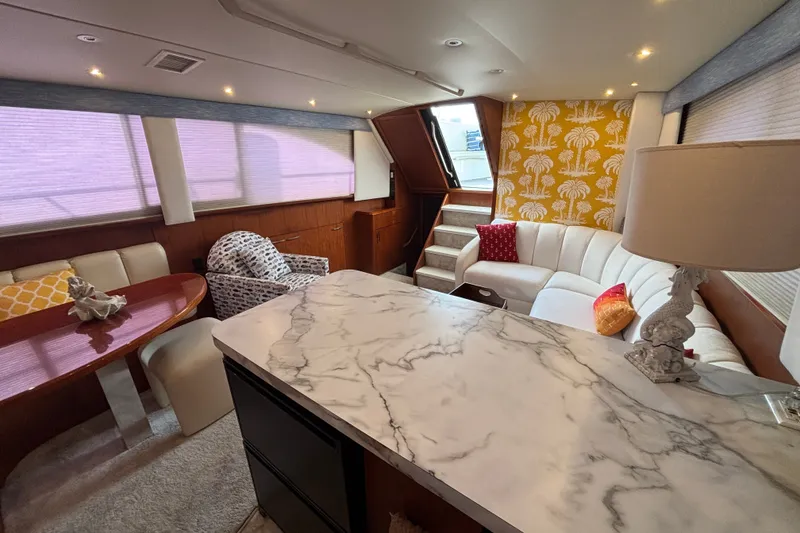 Slide: The Image of Luxurious interior of a 1995 Ocean 48 Cockpit Motor Yacht with elegant seating and marble countertop. - 16
