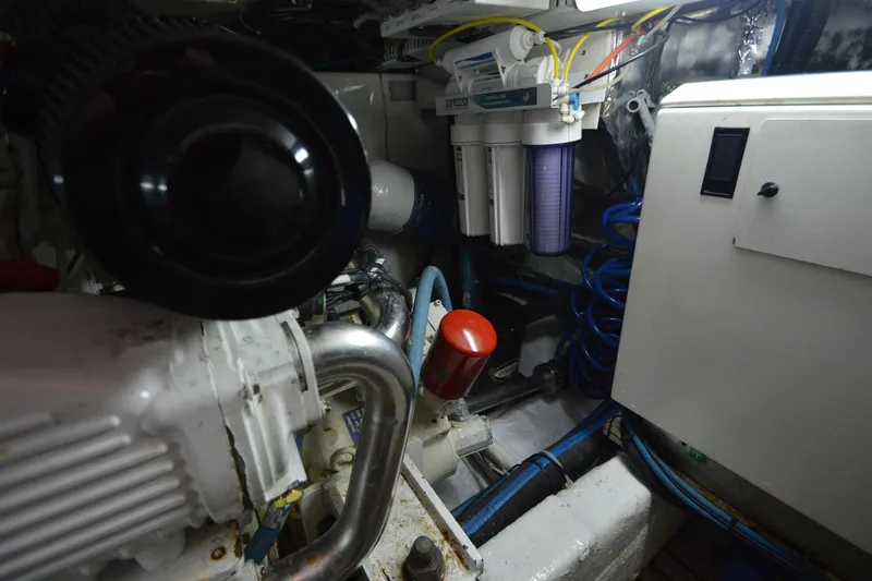 Slide: The Image of Engine room of 1995 Ocean 48 Cockpit Motor Yacht with visible machinery and components. - 52
