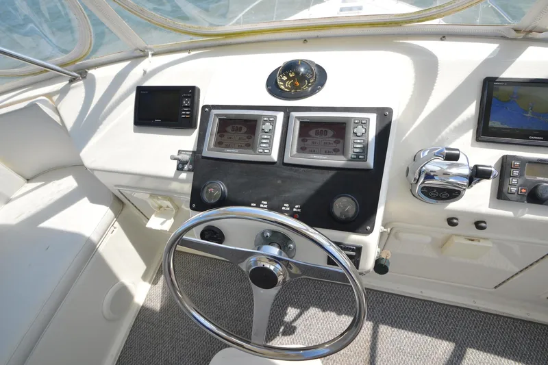 Slide: The Image of Cockpit of 1995 Ocean 48 Cockpit Motor Yacht with navigation instruments and steering wheel. - 80