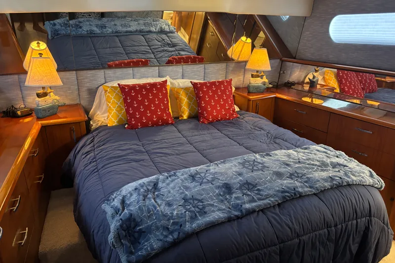 Slide: The Image of Luxurious bedroom in 1995 Ocean 48 Cockpit Motor Yacht with nautical-themed decor. - 20