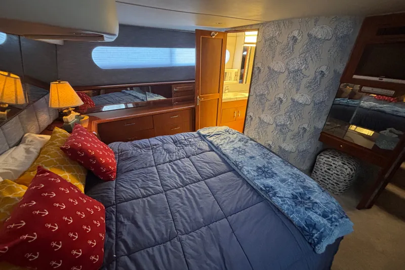 Slide: The Image of Cozy bedroom in 1995 Ocean 48 Cockpit Motor Yacht with nautical decor and soft lighting. - 21