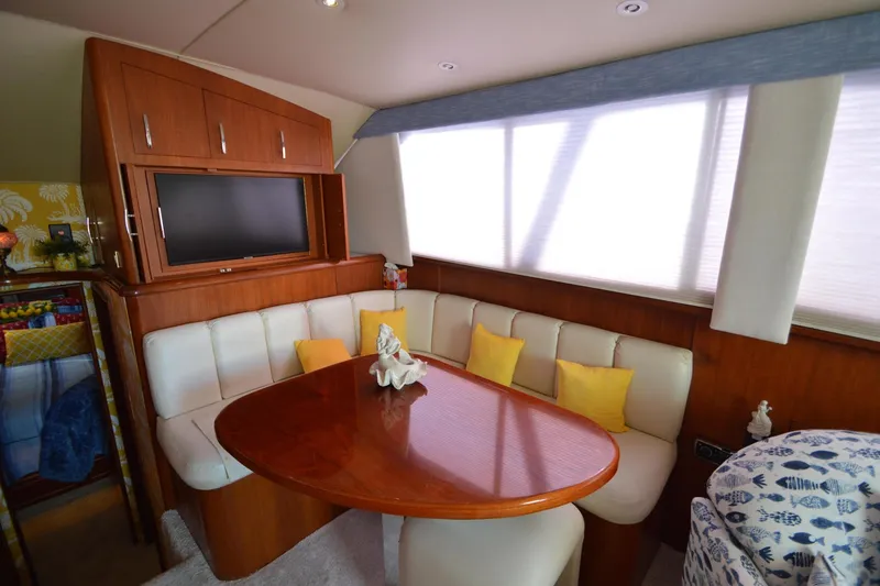 Slide: The Image of Interior of 1995 Ocean 48 Cockpit Motor Yacht with dining area and TV. - 9