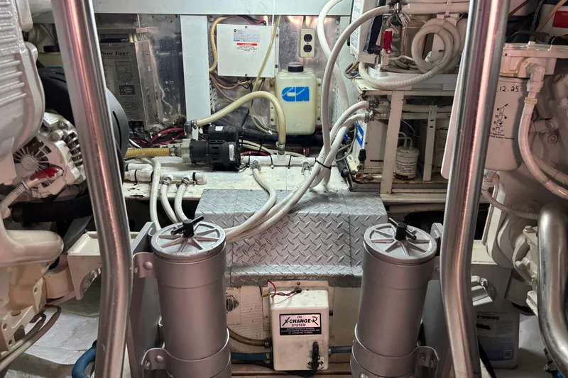 Slide: The Image of Engine room of a 1995 Ocean 48 Cockpit Motor Yacht, featuring mechanical components and piping. - 51