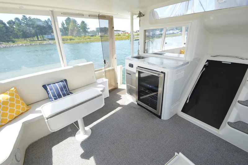 Slide: The Image of Luxurious interior of 1995 Ocean 48 Cockpit Motor Yacht with seating and kitchenette. - 68