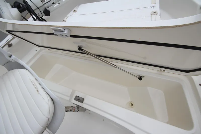 Slide: The Image of Open storage compartment on a 2014 Boston Whaler 210 Dauntless boat, showcasing interior space. - 12