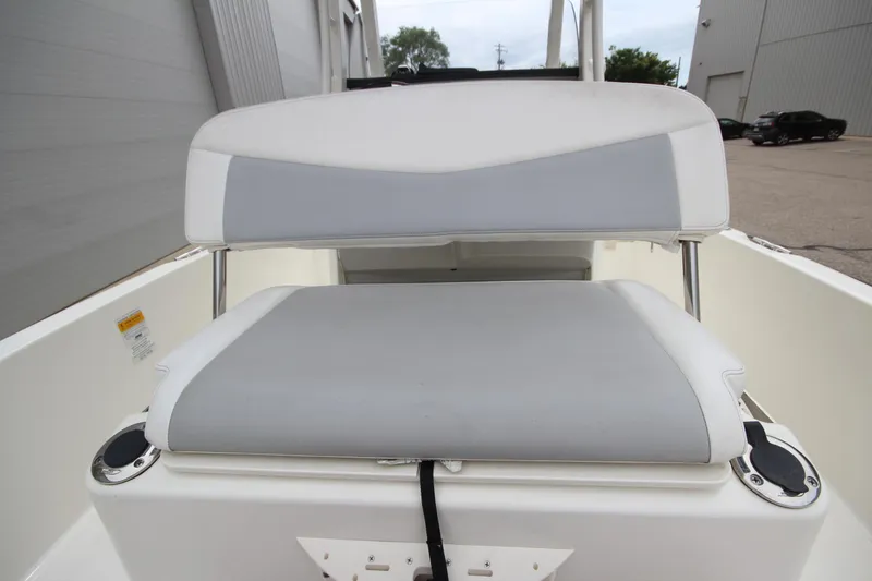 Slide: The Image of 2014 Boston Whaler 210 Dauntless boat seat with gray and white upholstery. - 16
