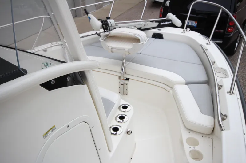 Slide: The Image of 2014 Boston Whaler 210 Dauntless boat interior with seating and fishing rod holders. - 24