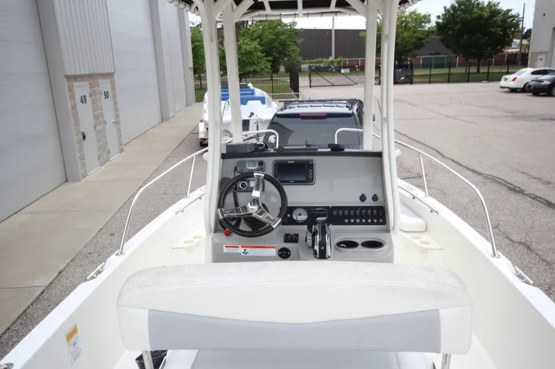 Slide: The Image of 2014 Boston Whaler 210 Dauntless boat interior with steering console and seating. - 3