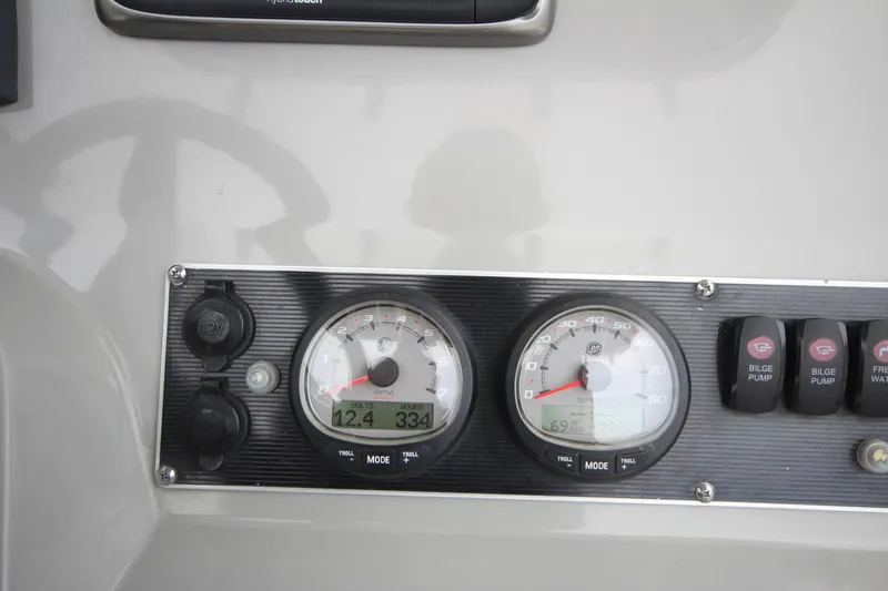 Slide: The Image of Dashboard of a 2014 Boston Whaler 210 Dauntless boat with gauges and switches. - 6