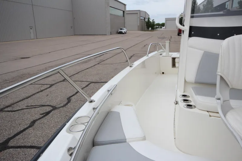 Slide: The Image of 2014 Boston Whaler 210 Dauntless boat interior with seating and cup holders. - 9