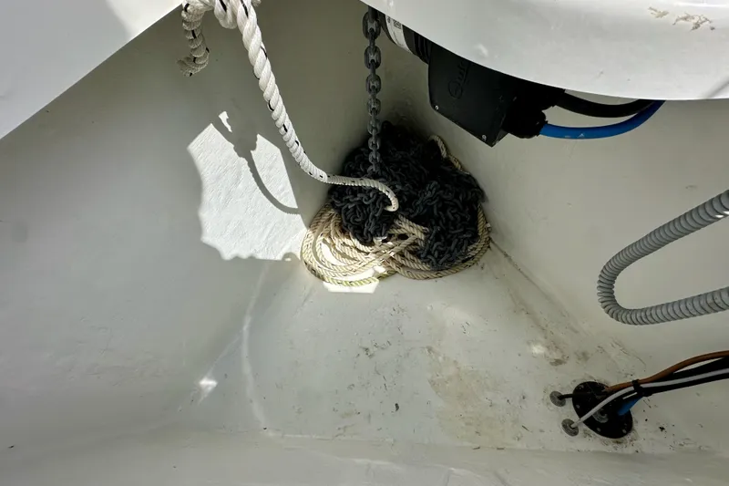 Slide: The Image of Anchor locker of 2024 Jeanneau Sun Odyssey 410 with ropes and chains. - 34