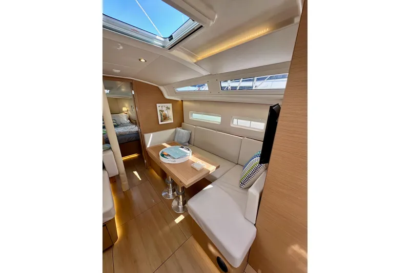 Slide: The Image of Interior of 2024 Jeanneau Sun Odyssey 410 yacht, featuring modern seating and natural light. - 70