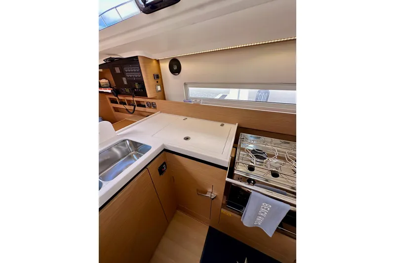 Slide: The Image of Modern kitchen interior of 2024 Jeanneau Sun Odyssey 410 yacht, featuring sleek design and appliances. - 76