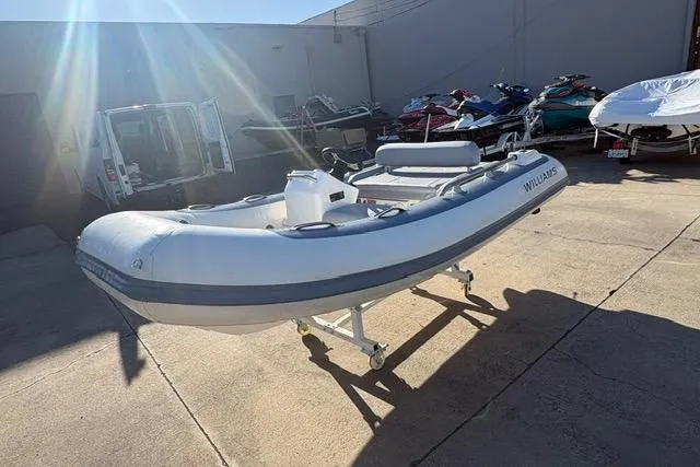 Slide: The Image of 2018 Williams 345 Sports Jet boat on display in a sunny outdoor setting. - 3