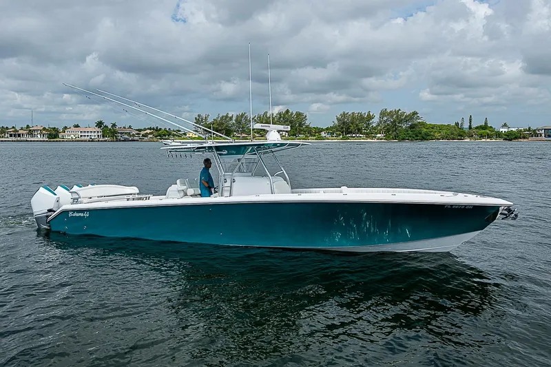 The Image of 2020 Bahama 41 boat cruising on a calm waterway under cloudy skies. - 0