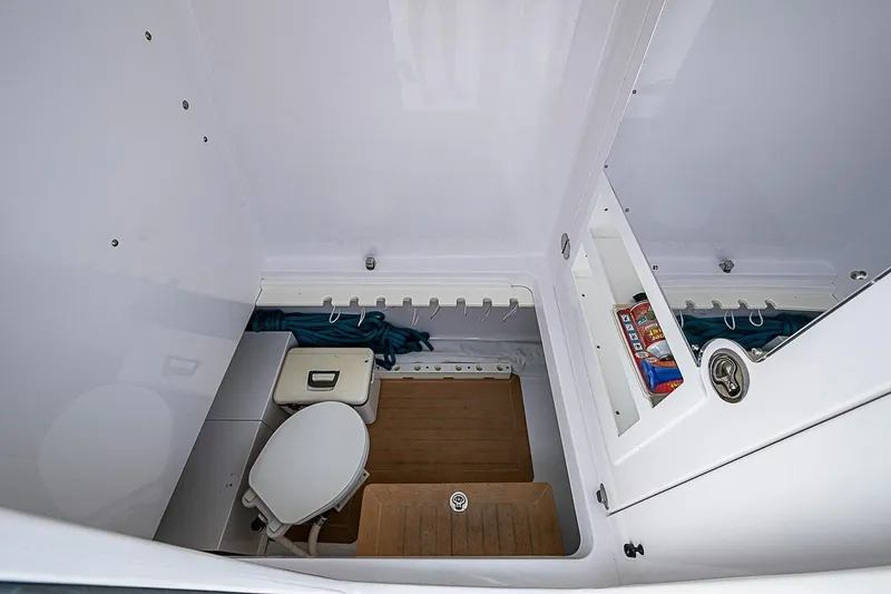 Slide: The Image of Interior of 2020 Bahama 41 boat showing compact bathroom with toilet and storage. - 14