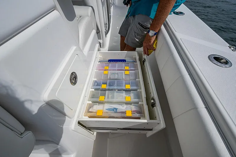 Slide: The Image of 2020 Bahama 41 boat with organized tackle storage drawer open. - 15