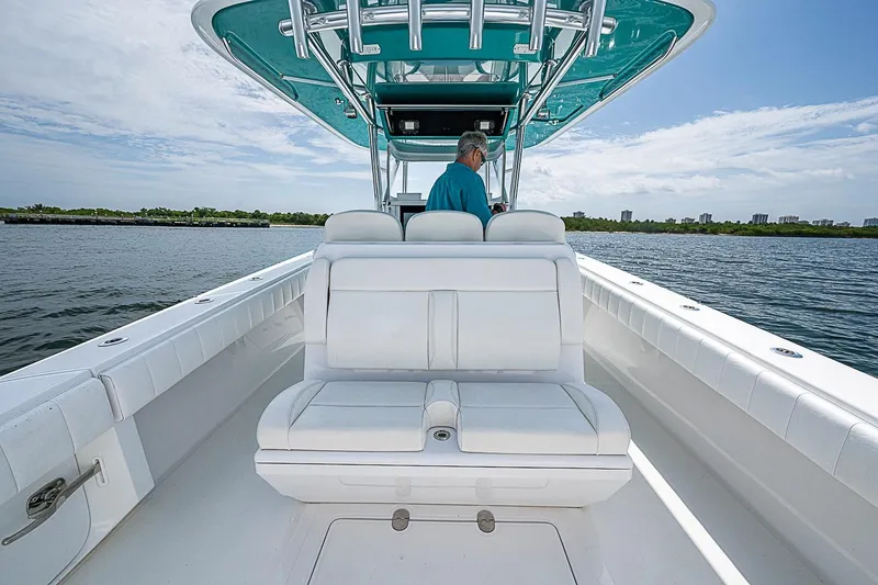 Slide: The Image of 2020 Bahama 41 boat with white seating, cruising on a calm waterway. - 18