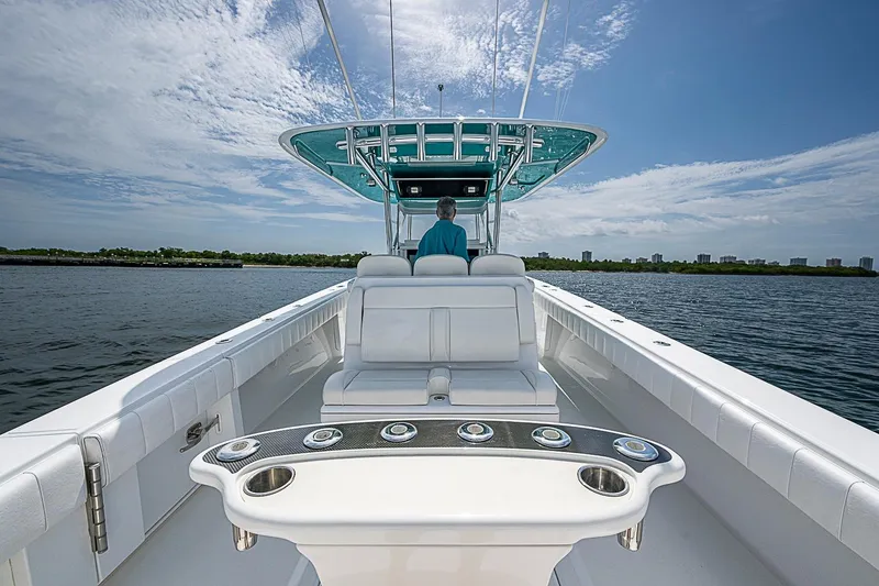 Slide: The Image of 2020 Bahama 41 boat on water, featuring spacious deck and modern helm. - 19
