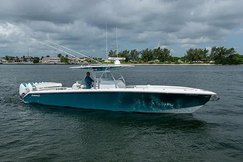 Slide: The Image of 2020 Bahama 41 boat cruising on a calm waterway under cloudy skies. - 25