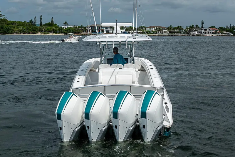 Slide: The Image of 2020 Bahama 41 boat with four engines cruising on a calm waterway. - 3