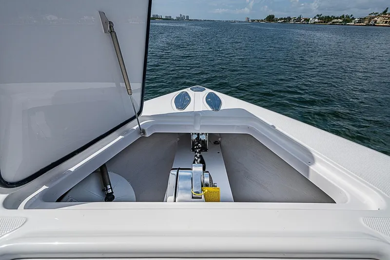Slide: The Image of Open anchor compartment on 2020 Bahama 41 boat, overlooking calm waters. - 5